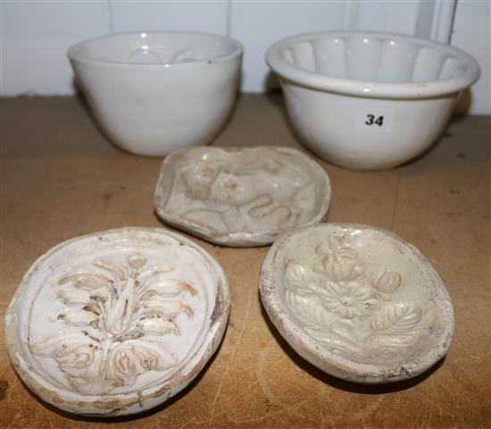 Three 18th century Italian majolica butter moulds, 2 jelly moulds and a pie centre